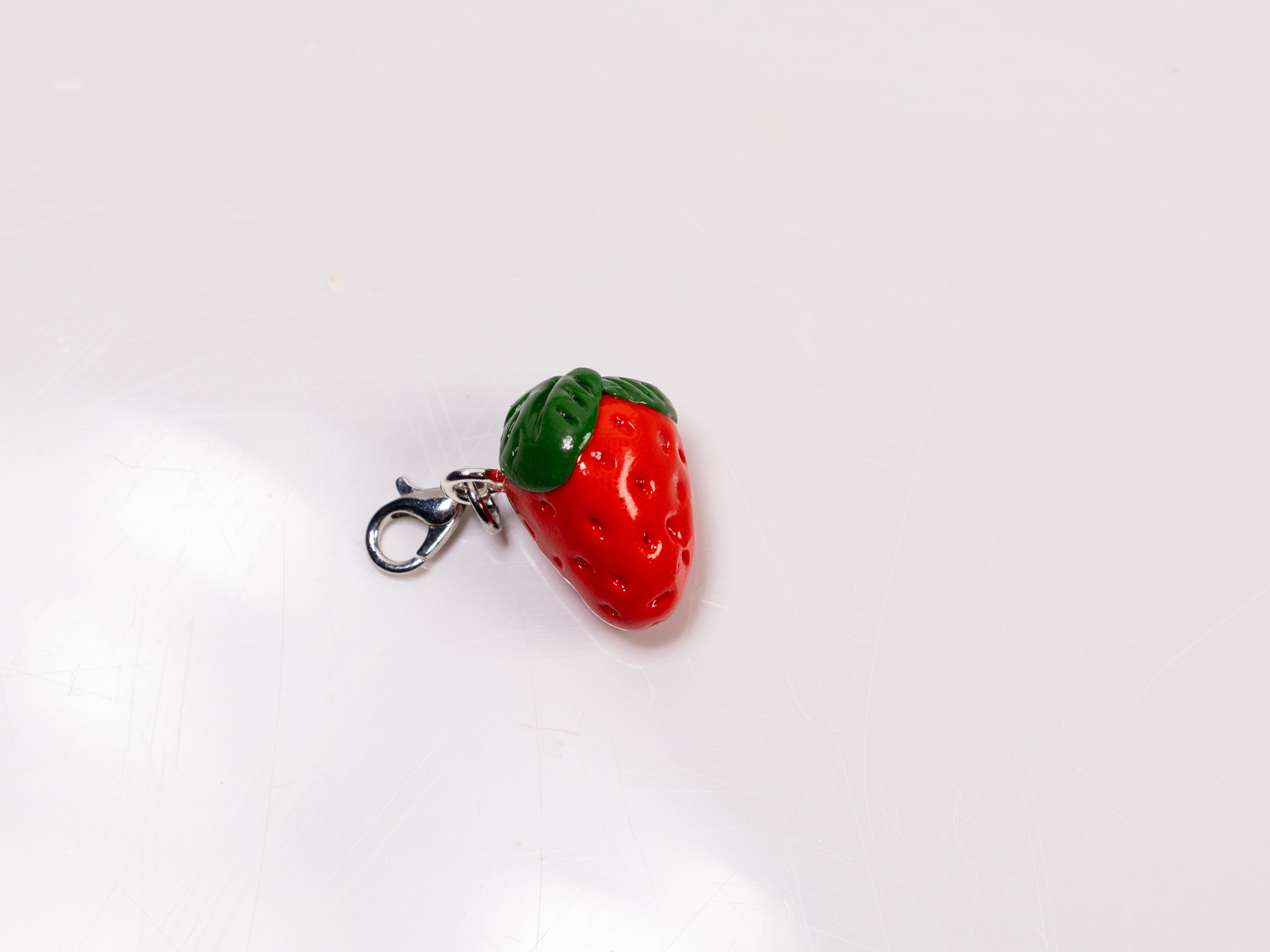 Miniature handmade strawberry clay charm