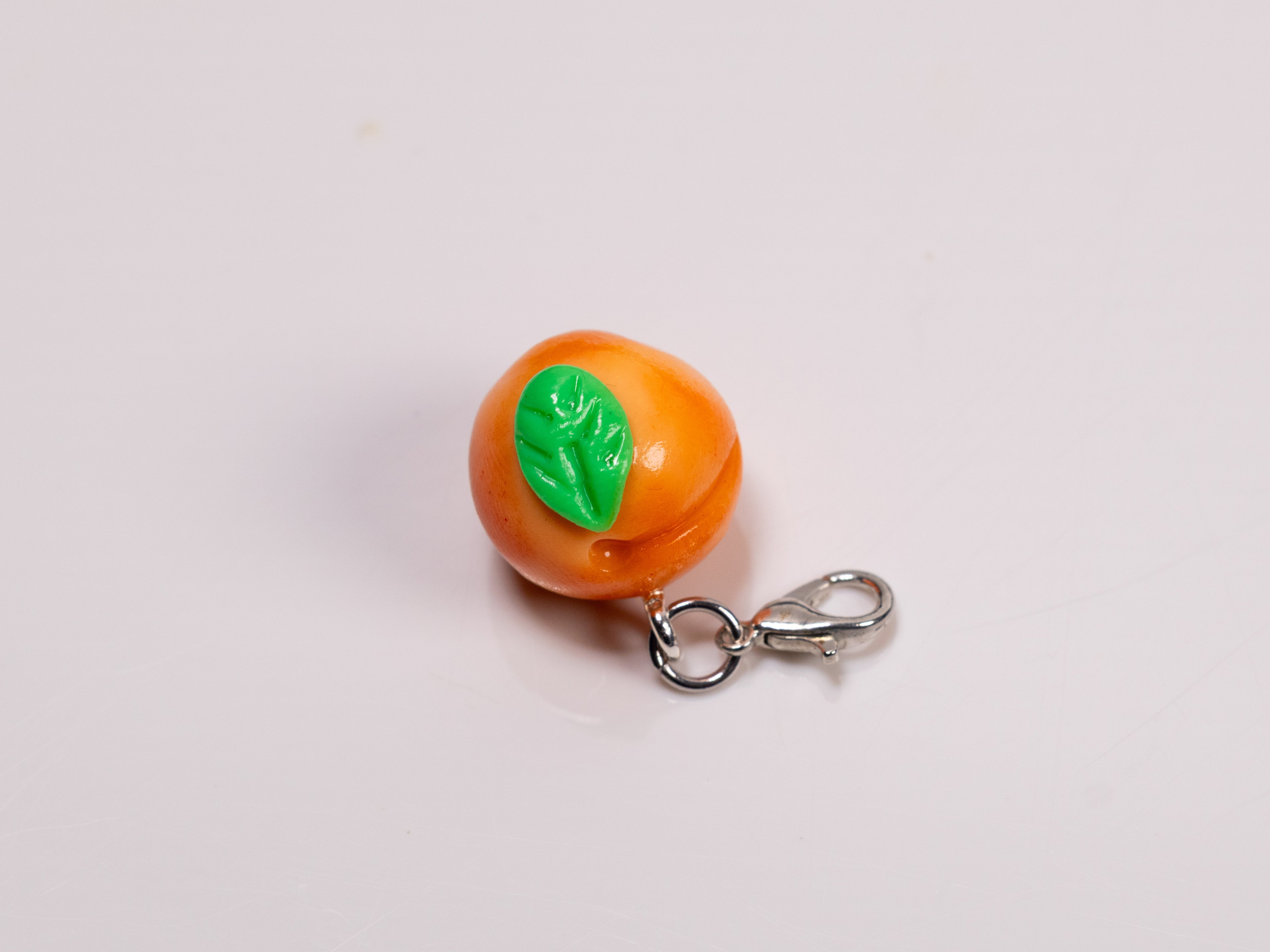 Miniature handmade peach clay charm